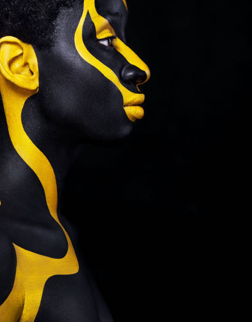 Art fashion makeup. An amazing woman with black makeup and leaking gold paint