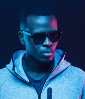 Close-up portrait of stylish black man, wearing hoodie and sunglasses