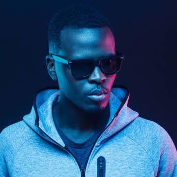 Close-up portrait of stylish black man, wearing hoodie and sunglasses