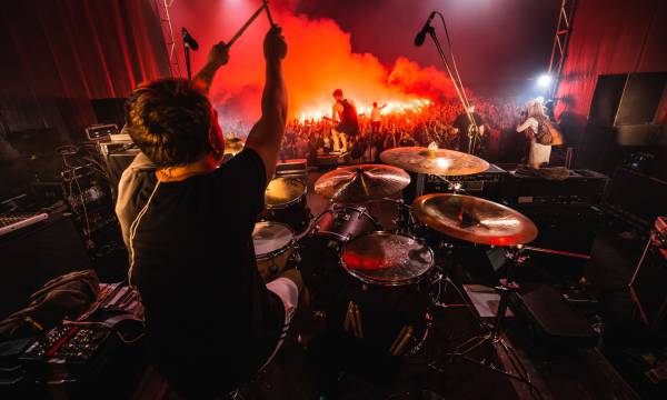 Drummer on stage. silhouette of music band in action on music stage. popular music rock band performs on stage.